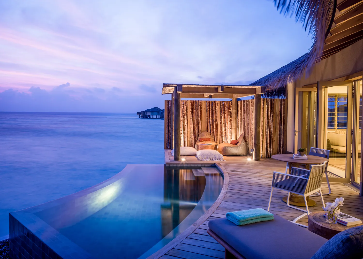 Sunset pool deck of an overwater villa at InterContinental Maldives